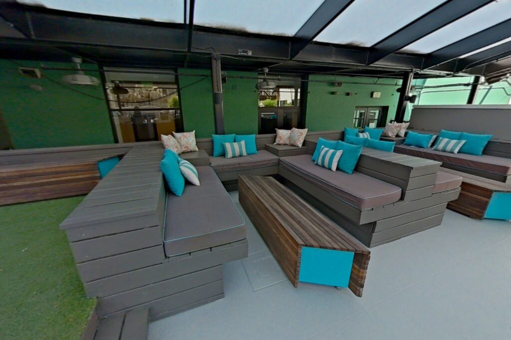 Outdoor lounge with lots of soft seating and covered top