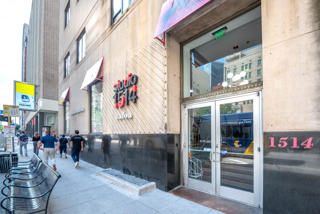 Exterior of Studio 1514 salon with people walking on the sidewalk in front of the building entrance.